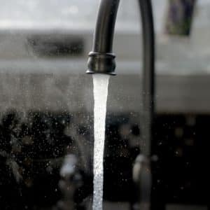 a faucet running water from a kitchen sink